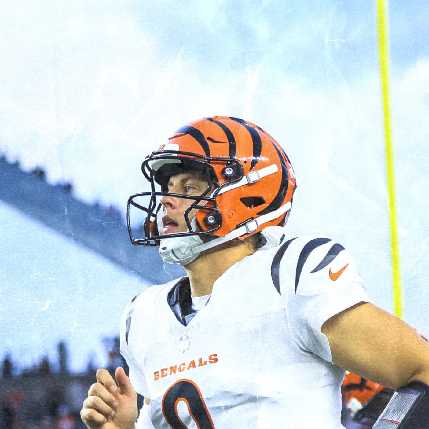 Joe Burrow of the Cincinnati Bengals jogs onto the field in the white uniform.