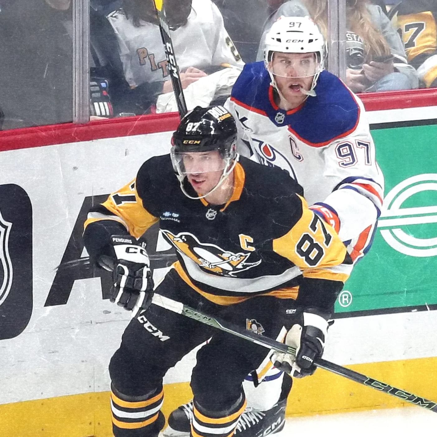 Sidney Crosby of the Pittsburgh Penguins and Connor McDavid of the Edmonton Oilers battle along the boards