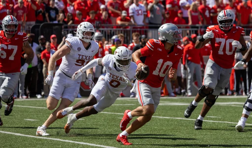 Ohio State Buckeyes running back cuts upfield against a Texas Longhorns defender