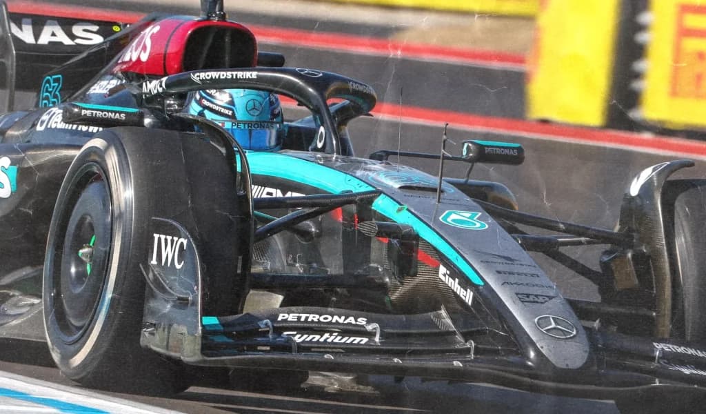 A Mercedes Formula 1 car up close through a corner at speed.