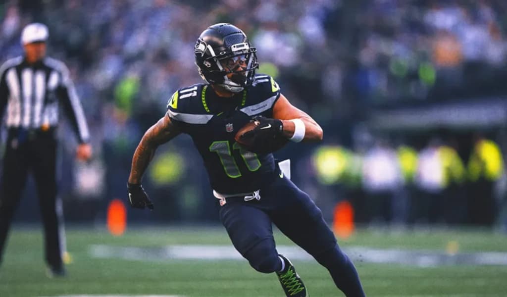 A Seattle Seahawks receiver cuts upfield with the ball.