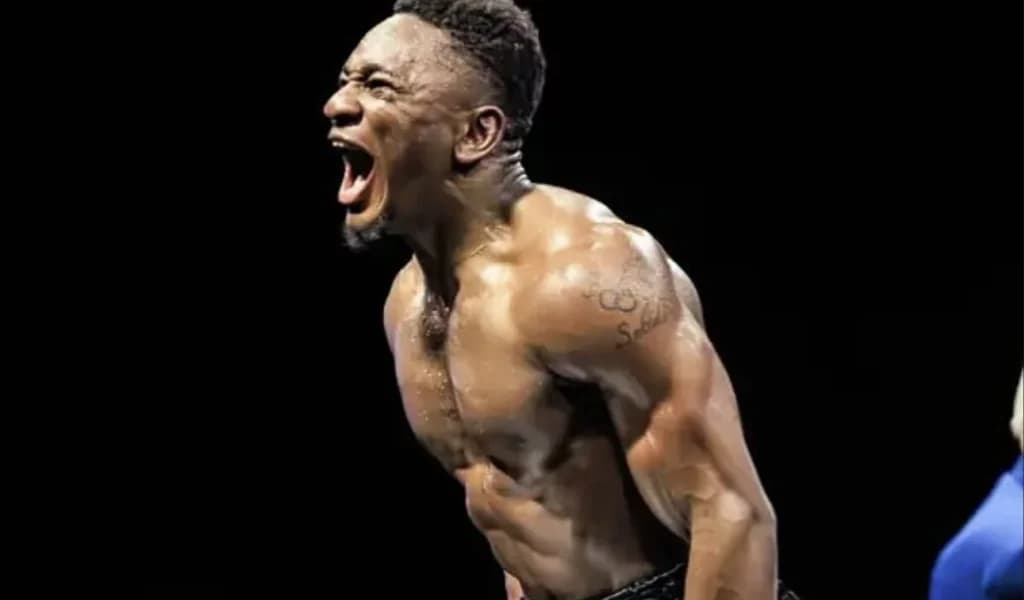 Christian Mbilli roars in celebration in the ring.