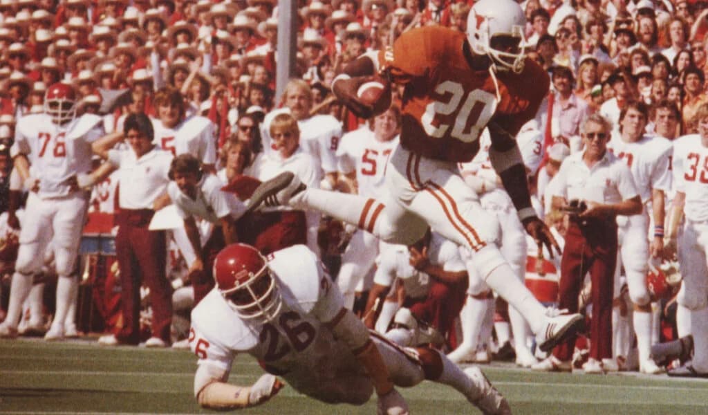 Vintage photo of a Texas Longhorns runner leaping over an Oklahoma defender